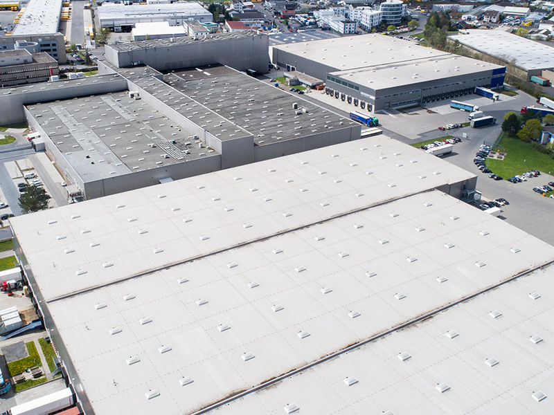 Bird's eye view of industrial building with flat roof made of thermoplastic material