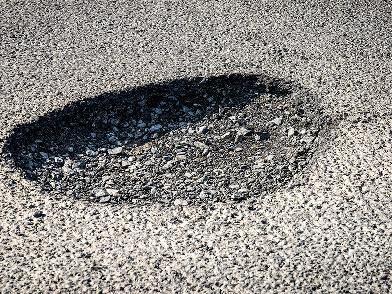 Asphalt with a pothole