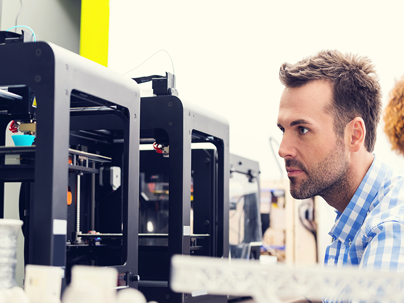 Man at a 3D printer made of thermoplastic polyolefins