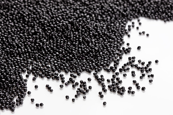 Black plastic granules on a white background