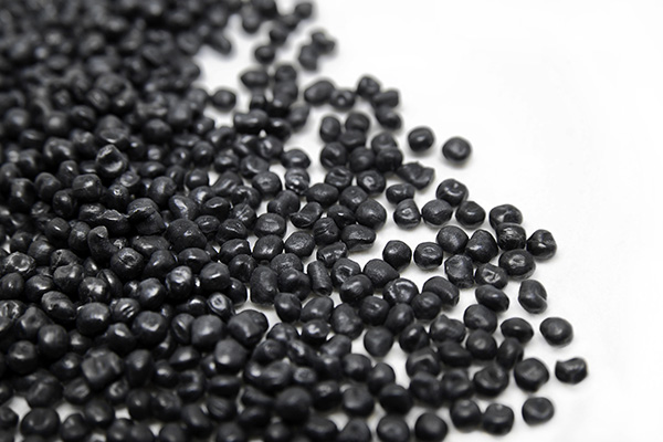 Black plastic granules on a white background